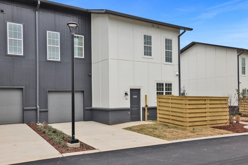 A modern two-story townhouse with fenced pet yard at West Row Lofts and Townhomes in Birmingham, AL